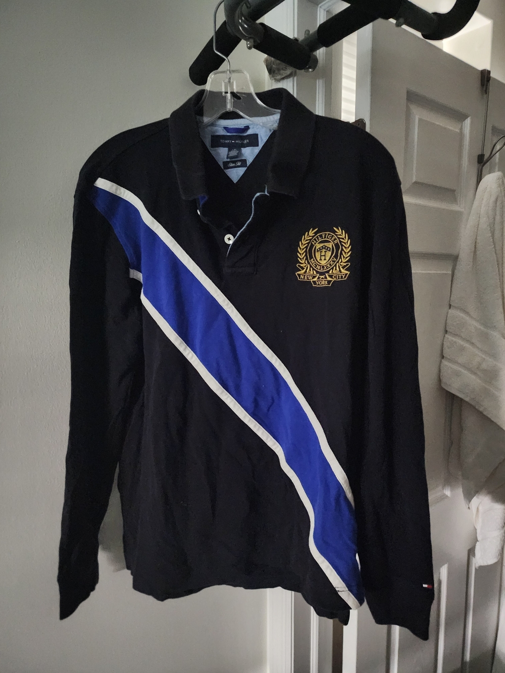 Tommy Hilfiger Black Long-Sleeve Polo with Blue Diagonal Stripe and Gold Crest